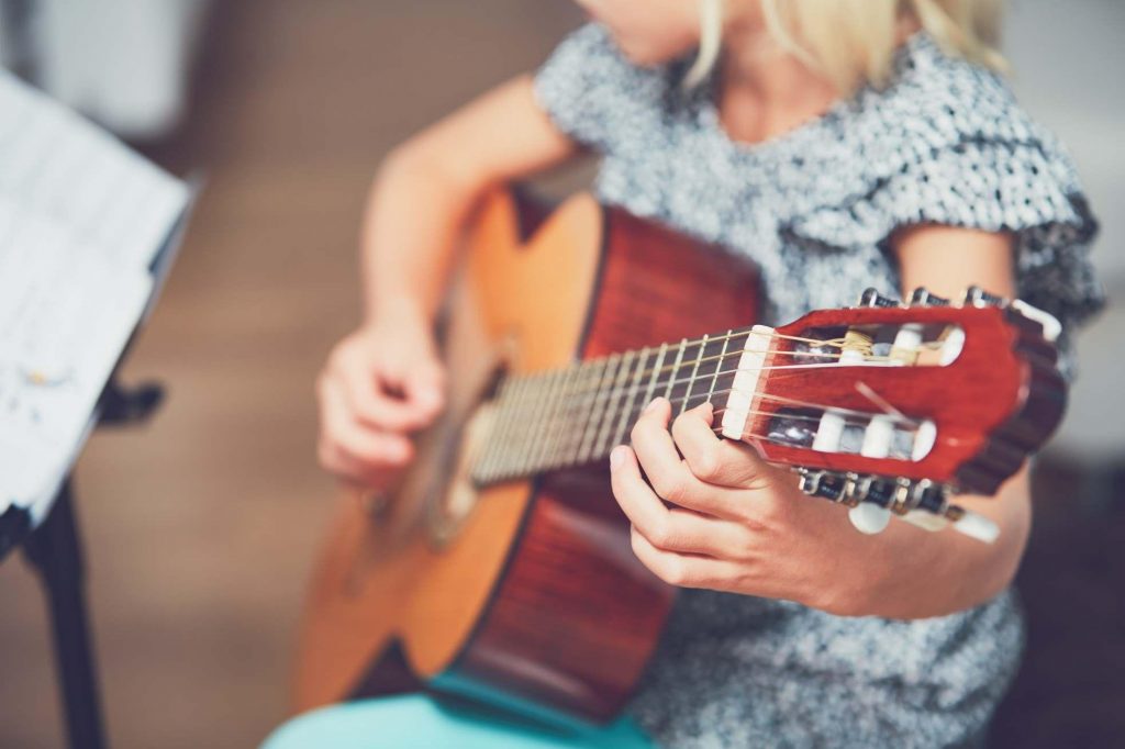 girl playing the guitar